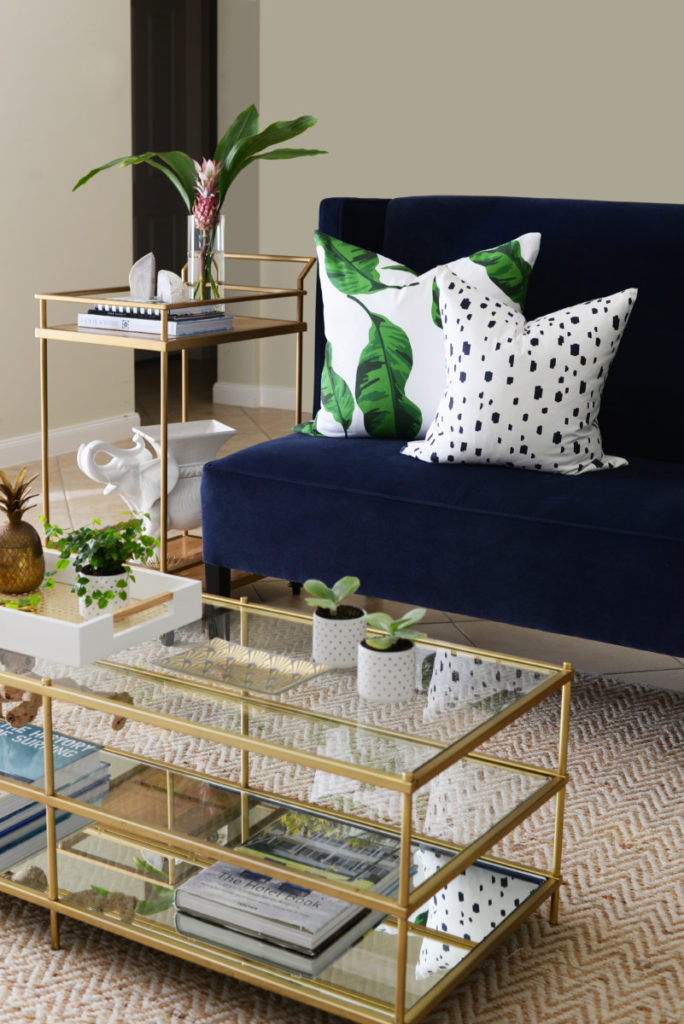 fall_living_room_navy_velvet_settee_banana_leaves_gold_brass_coffee_table_palm_beach