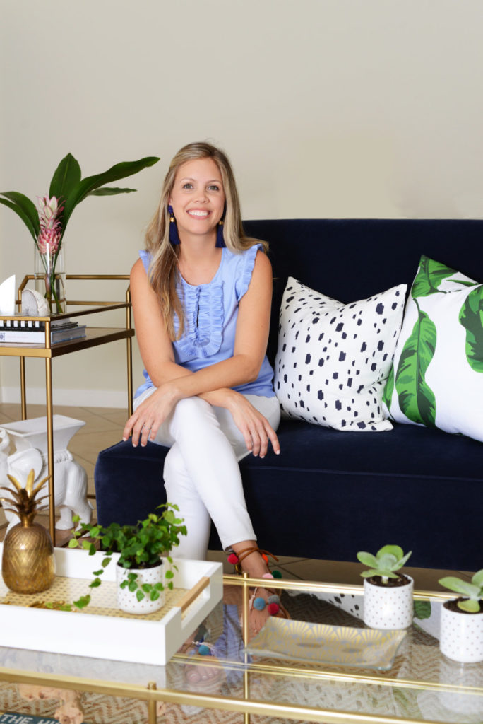 fall_living_room_navy_velvet_settee_banana_leaves_gold_brass_coffee_table_palm_beach